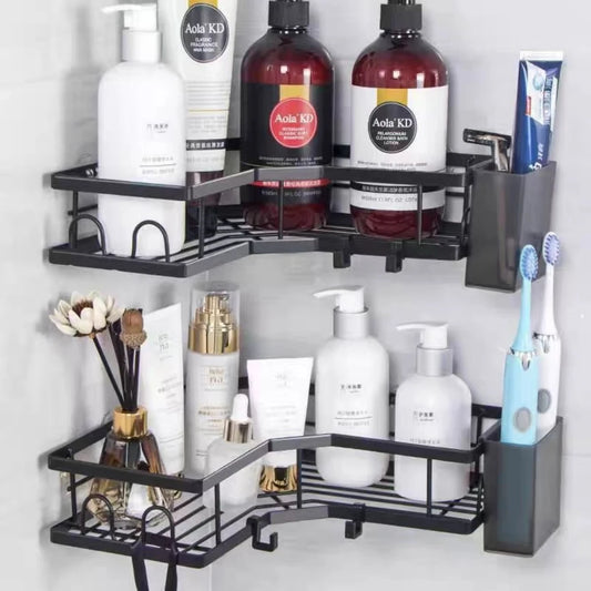 Black stainless steel corner shower caddy mounted on tile holding toiletries and a toothbrush holder